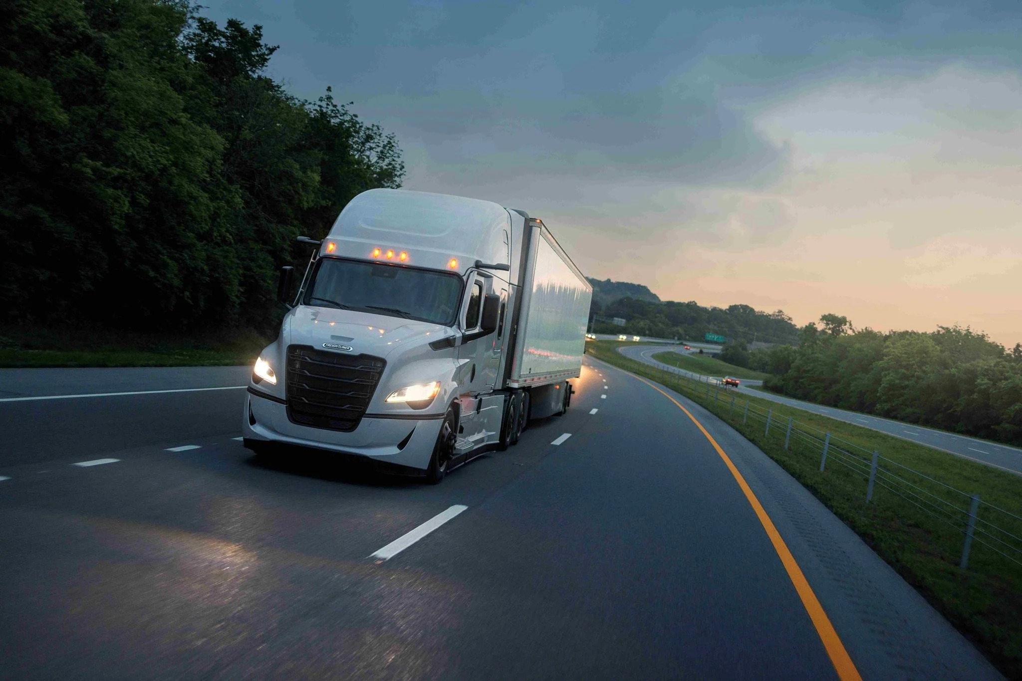 Freightliner semi truck driving on a road